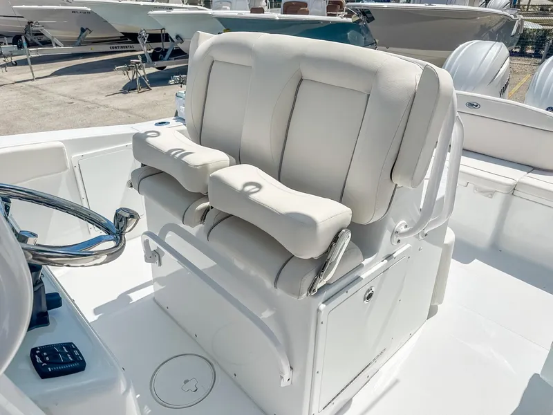 Slide: The Image of 2025 Sea Hunt Ultra 275 SE boat interior with dual white captain's chairs. - 13