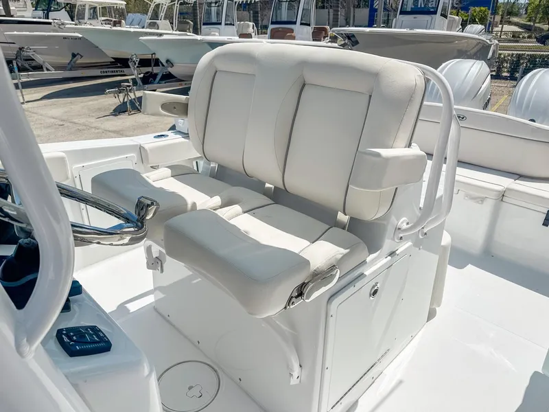 Slide: The Image of 2025 Sea Hunt Ultra 275 SE boat interior with white cushioned seating and steering wheel. - 14