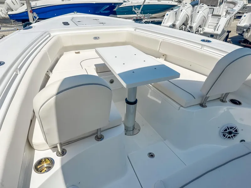 Slide: The Image of 2025 Sea Hunt Ultra 275 SE boat interior with white seating and table. - 18
