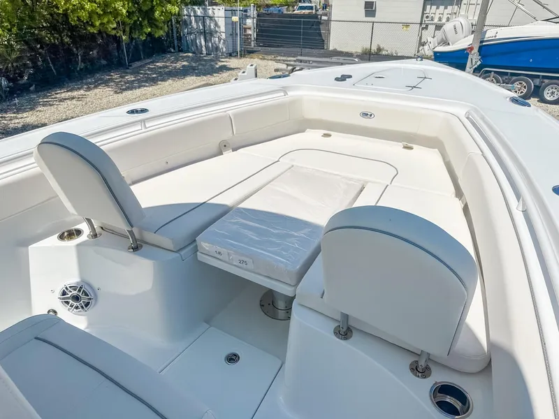 Slide: The Image of 2025 Sea Hunt Ultra 275 SE boat interior with white seating and deck. - 21