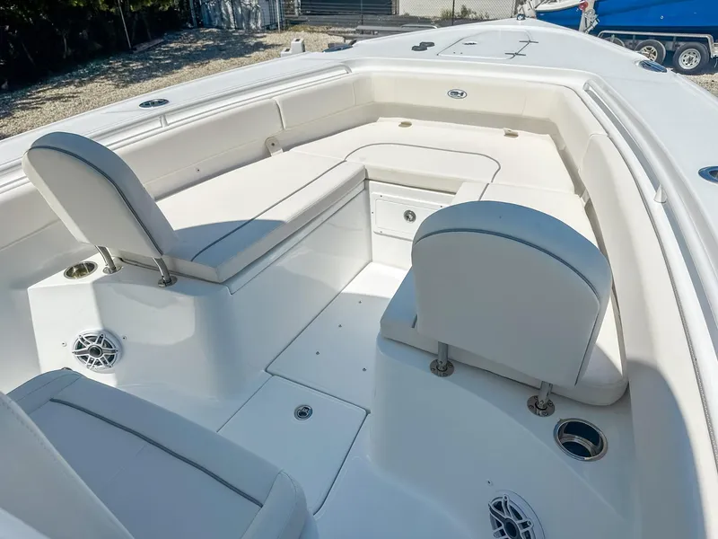 Slide: The Image of 2025 Sea Hunt Ultra 275 SE boat interior with white seating and storage compartments. - 23