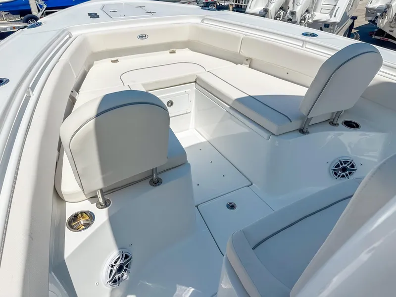 Slide: The Image of 2025 Sea Hunt Ultra 275 SE boat interior with white seating and storage compartments. - 24