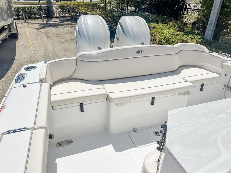 Slide: The Image of 2025 Sea Hunt Ultra 275 SE boat interior with dual engines and cushioned seating. - 7