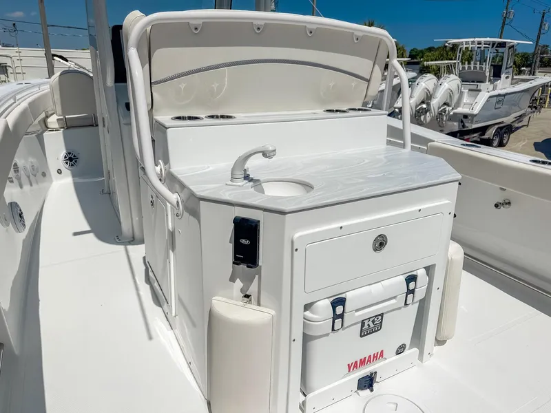 Slide: The Image of 2025 Sea Hunt Ultra 275 SE boat interior with sink and storage area. - 9
