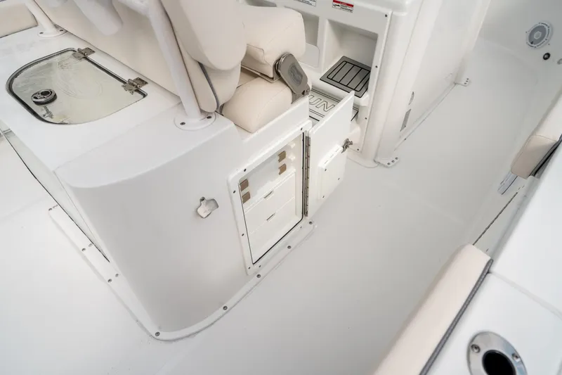 Slide: The Image of 2025 Sea Hunt Gamefish 27 FS interior, featuring storage compartments and seating. - 19