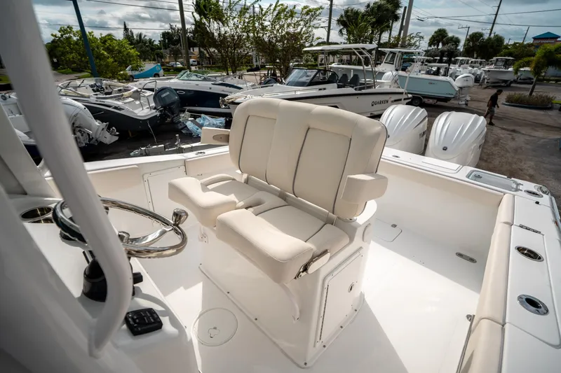 Slide: The Image of 2025 Sea Hunt Gamefish 27 FS boat interior with dual seats and steering wheel. - 30