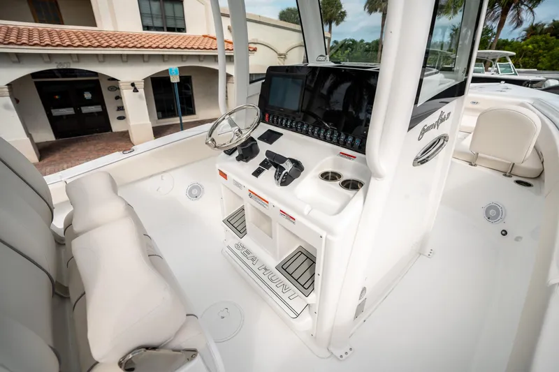 Slide: The Image of 2025 Sea Hunt Gamefish 27 FS boat interior with modern helm and seating. - 25