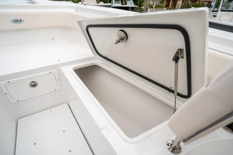 Slide: The Image of 2025 Sea Hunt Gamefish 27 FS boat storage compartment open, showcasing interior space. - 42