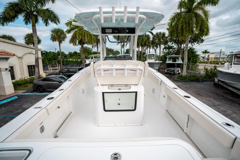 Slide: The Image of 2025 Sea Hunt Gamefish 27 FS boat, spacious deck, palm trees in background. - 9