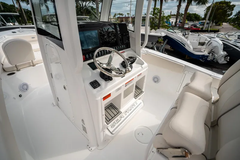 Slide: The Image of 2025 Sea Hunt Gamefish 27 FS boat interior with steering console and seating. - 26