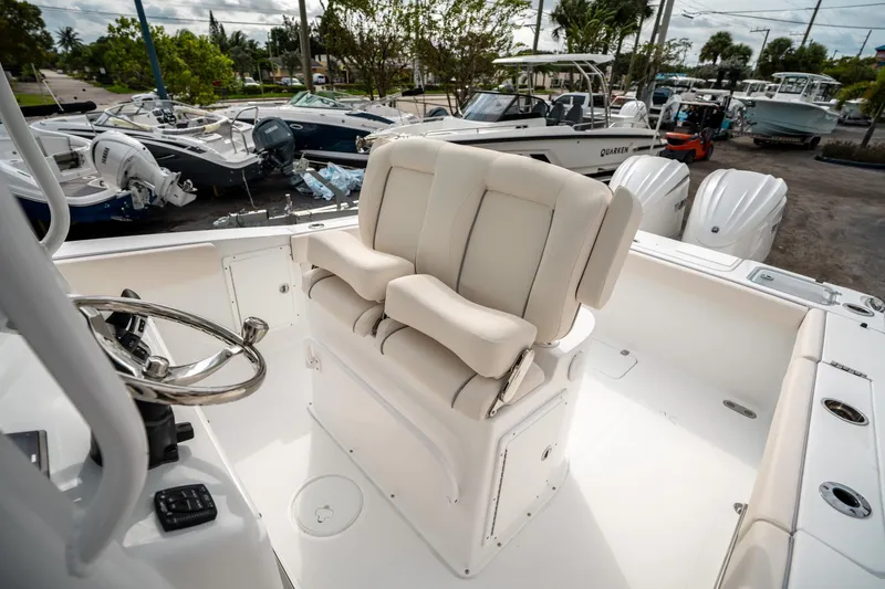 Slide: The Image of 2025 Sea Hunt Gamefish 27 FS boat interior with helm seat and steering wheel. - 27