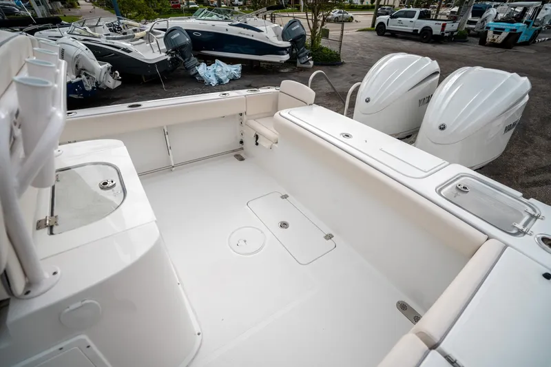 Slide: The Image of 2025 Sea Hunt Gamefish 27 FS boat interior with dual engines, spacious deck, and storage compartments. - 11