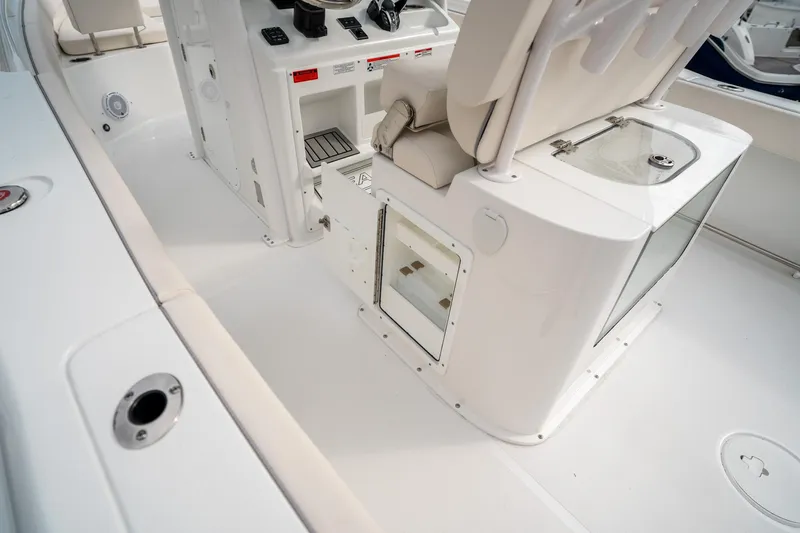 Slide: The Image of 2025 Sea Hunt Gamefish 27 FS boat interior, featuring seating and storage compartments. - 18