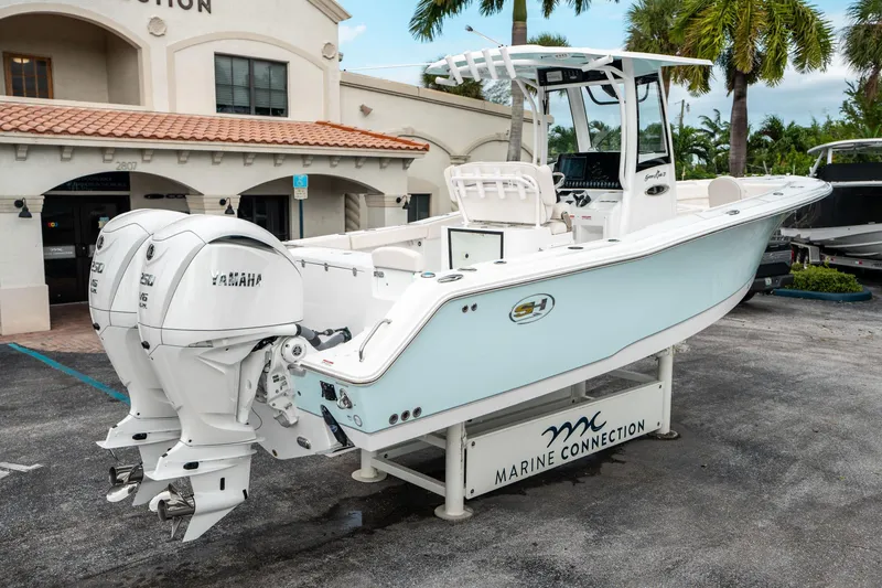 Slide: The Image of 2025 Sea Hunt Gamefish 27 FS boat with twin Yamaha engines at Marine Connection dealership. - 2
