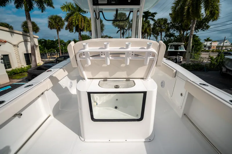 Slide: The Image of 2025 Sea Hunt Gamefish 27 FS boat interior with rod holders and storage compartment. - 16
