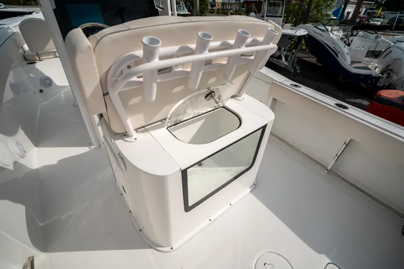Slide: The Image of 2025 Sea Hunt Gamefish 27 FS boat interior with rod holders and storage compartment. - 17