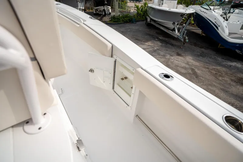 Slide: The Image of 2025 Sea Hunt Gamefish 27 FS boat interior with storage compartment and rod holder. - 20