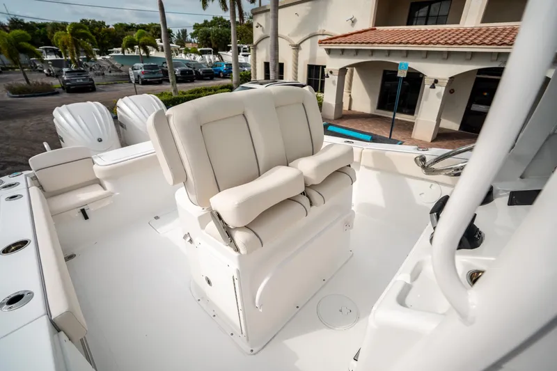 Slide: The Image of 2025 Sea Hunt Gamefish 27 FS boat interior with cushioned seating and dual outboard motors. - 28