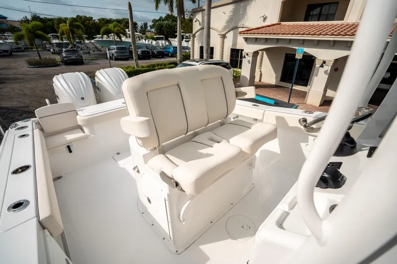 Slide: The Image of 2025 Sea Hunt Gamefish 27 FS boat interior with cushioned seating and dual engines. - 29