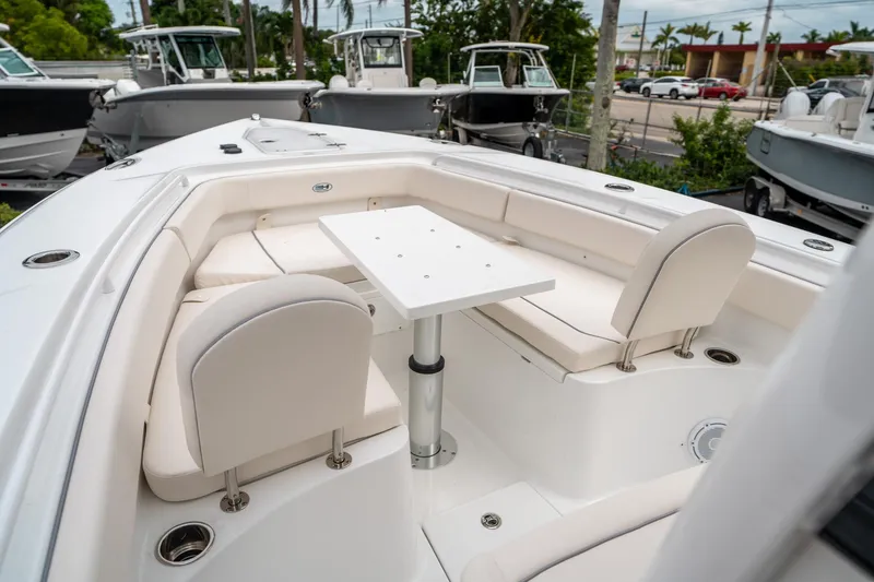Slide: The Image of 2025 Sea Hunt Gamefish 27 FS boat interior with seating and table. - 37