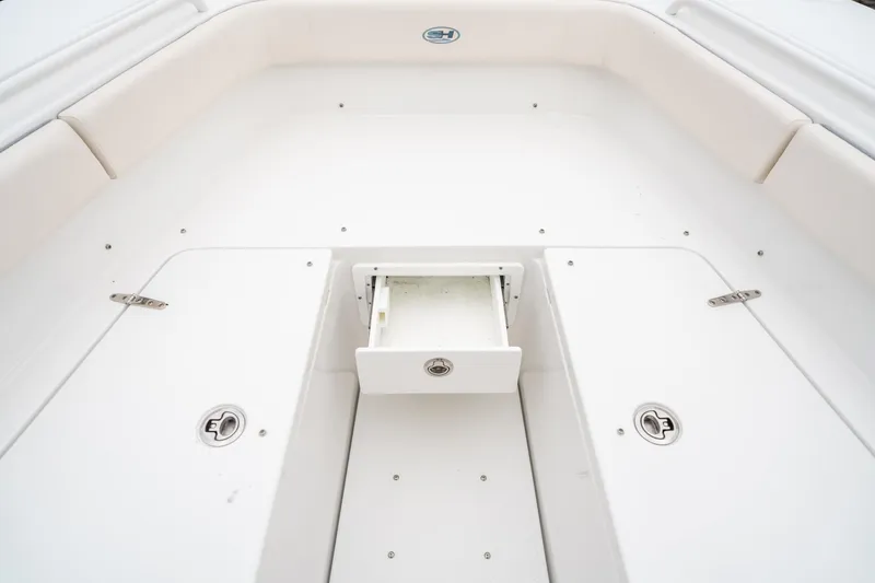 Slide: The Image of 2025 Sea Hunt Gamefish 27 FS boat interior with storage compartment open. - 44