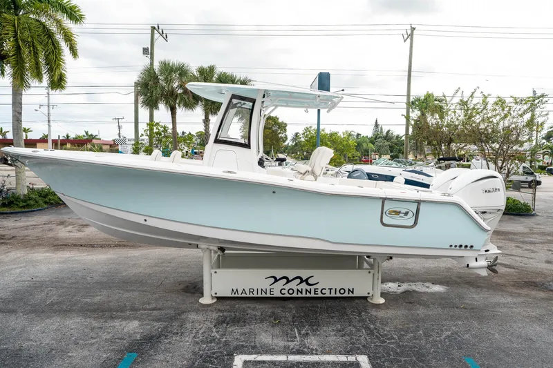 Slide: The Image of 2025 Sea Hunt Gamefish 27 FS boat displayed outdoors at Marine Connection dealership. - 5