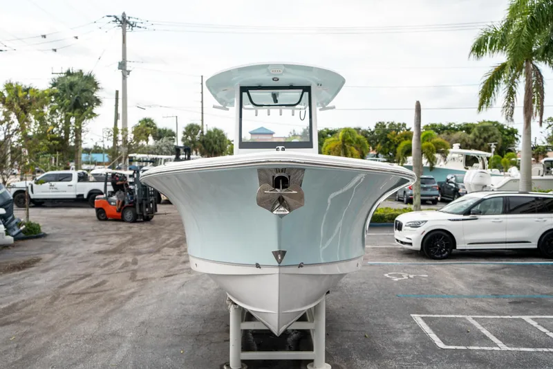 Slide: The Image of 2025 Sea Hunt Gamefish 27 FS boat displayed in a parking lot with palm trees. - 7