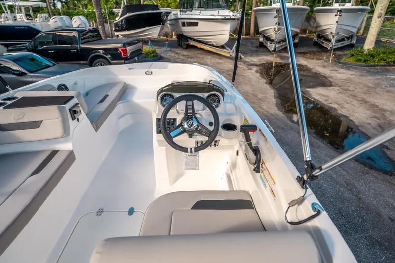Slide: The Image of 2025 Hurricane SunDeck Sport 185 OB boat interior with steering wheel and seating. - 17