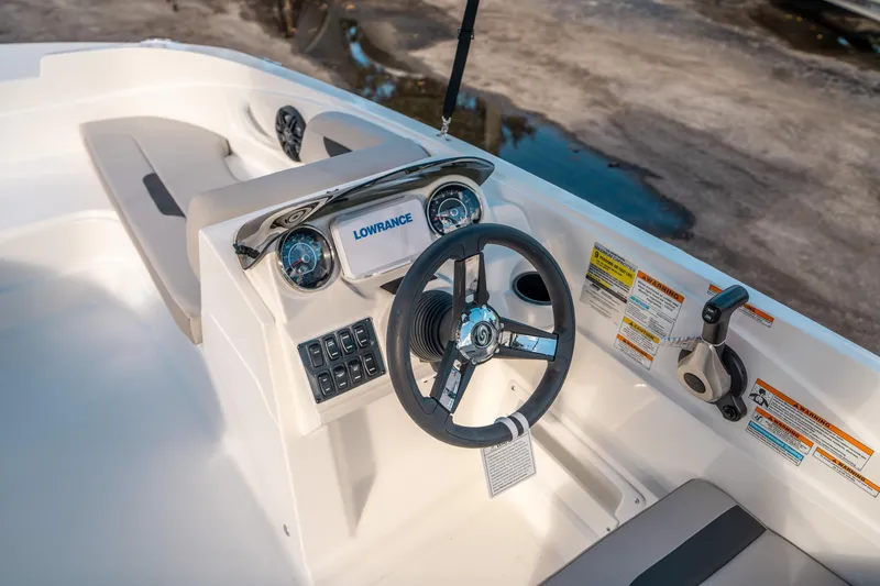 Slide: The Image of 2025 Hurricane SunDeck Sport 185 OB boat dashboard with steering wheel and control panel. - 18