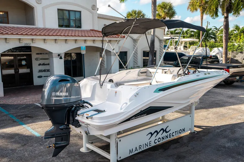 Slide: The Image of 2025 Hurricane SunDeck Sport 185 OB boat with Yamaha engine at Marine Connection dealership. - 2