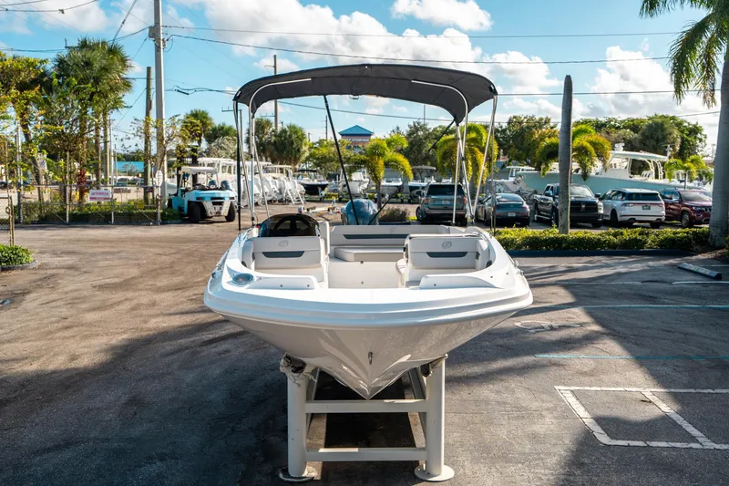Slide: The Image of 2025 Hurricane SunDeck Sport 185 OB boat displayed in a sunny outdoor setting. - 7