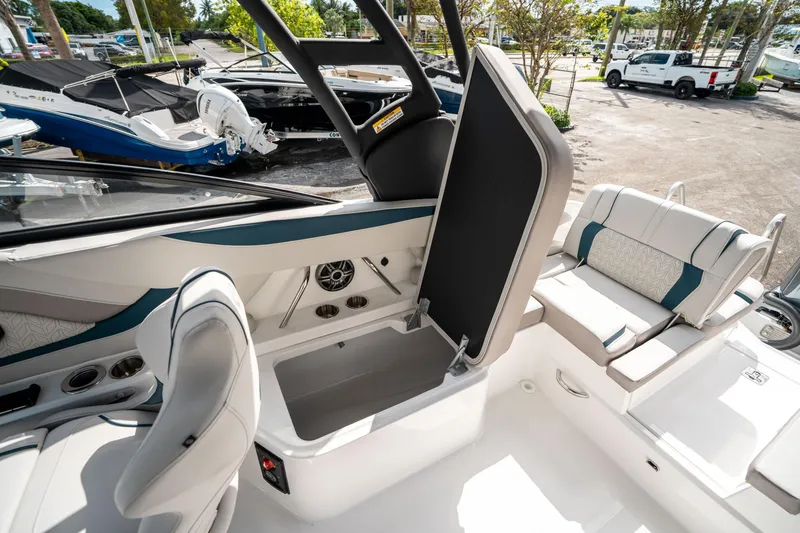 Slide: The Image of 2025 Hurricane SunDeck 2600 OB interior with open storage compartment and seating area. - 13