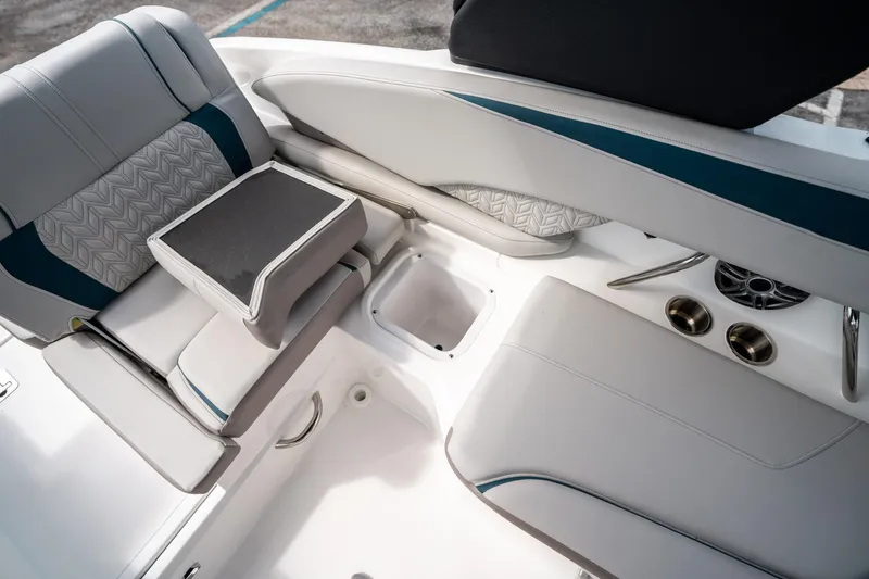 Slide: The Image of 2025 Hurricane SunDeck 2600 OB boat interior with cushioned seating and cup holders. - 15