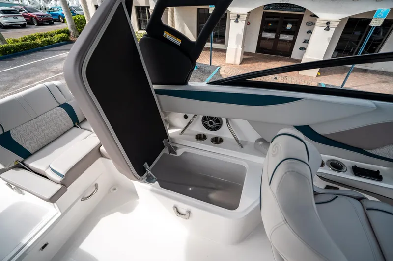 Slide: The Image of 2025 Hurricane SunDeck 2600 OB boat interior with open storage compartment and seating. - 16