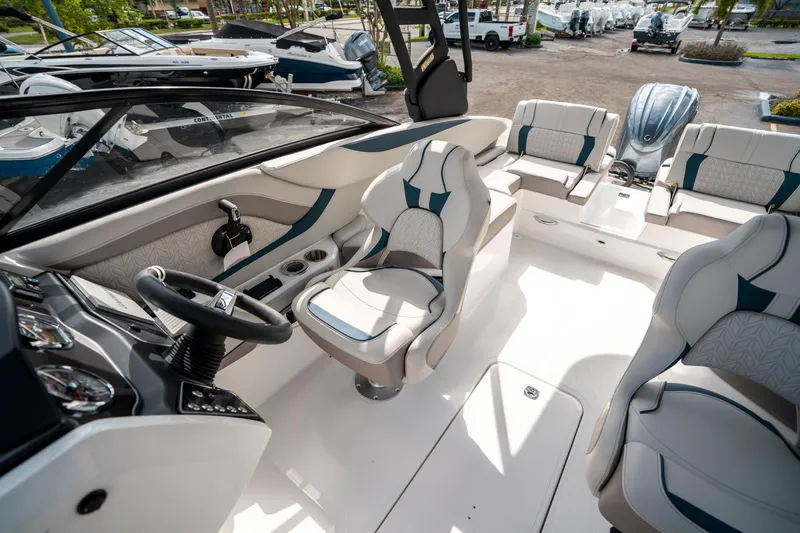 Slide: The Image of 2025 Hurricane SunDeck 2600 OB boat interior with modern seating and steering console. - 20