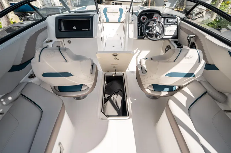 Slide: The Image of 2025 Hurricane SunDeck 2600 OB boat interior with modern seating and dashboard design. - 25