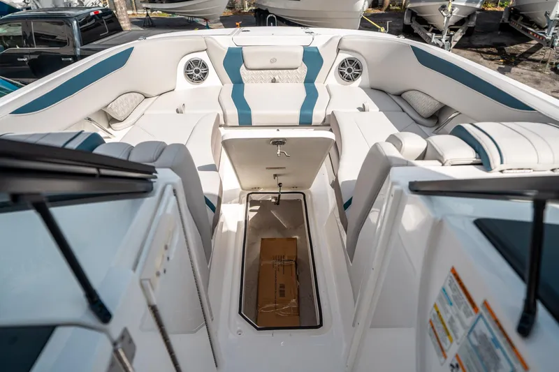 Slide: The Image of 2025 Hurricane SunDeck 2600 OB boat interior with seating and storage compartment. - 34