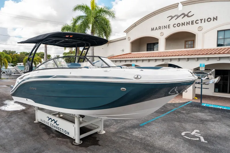 Slide: The Image of 2025 Hurricane SunDeck 2600 OB boat displayed at Marine Connection dealership. - 8