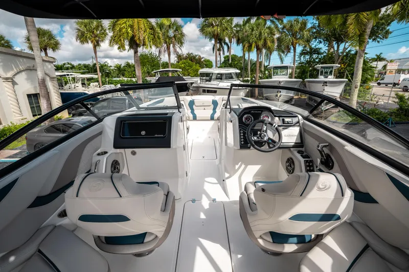 Slide: The Image of 2025 Hurricane SunDeck 2600 OB boat interior with modern dashboard and seating. - 17
