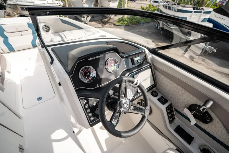 Slide: The Image of 2025 Hurricane SunDeck 2600 OB boat dashboard with steering wheel and gauges. - 19