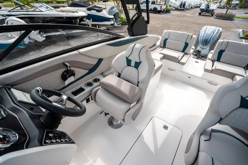 Slide: The Image of 2025 Hurricane SunDeck 2600 OB boat interior with modern seating and steering wheel. - 21
