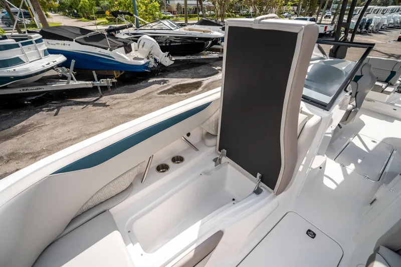 Slide: The Image of 2025 Hurricane SunDeck 2600 OB boat interior with storage compartment and seating. - 30