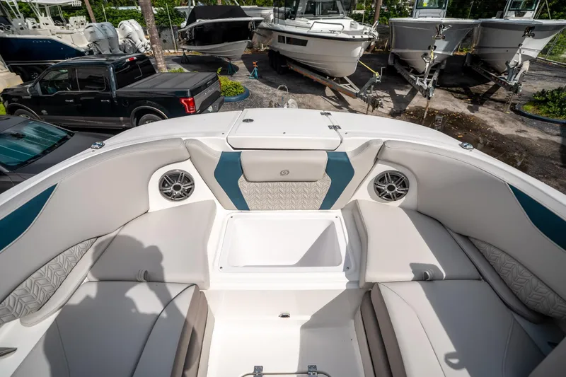 Slide: The Image of 2025 Hurricane SunDeck 2600 OB boat interior with cushioned seating and speakers. - 31