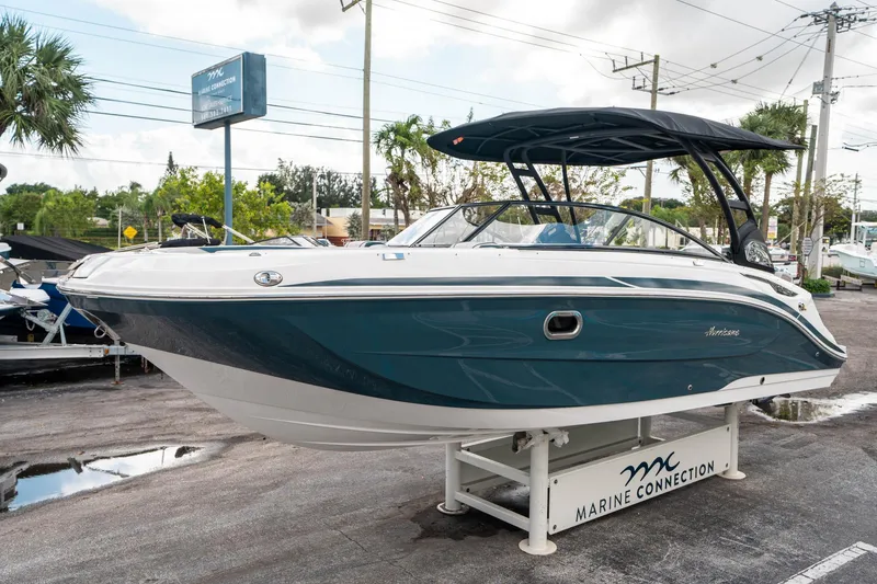 Slide: The Image of 2025 Hurricane SunDeck 2600 OB boat displayed at Marine Connection dealership. - 6