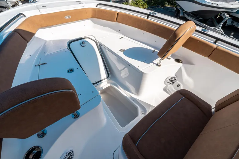 Slide: The Image of 2025 Sea Hunt Ultra 255 SE boat interior with brown seating and storage compartments. - 40