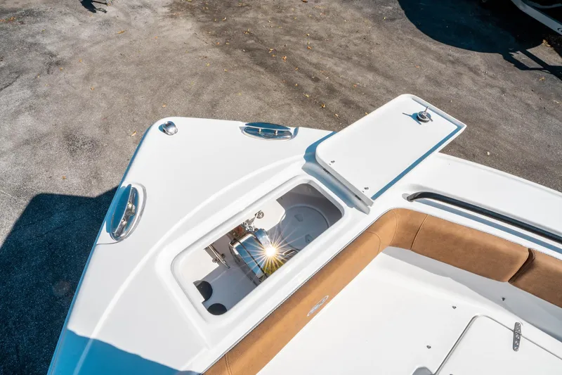 Slide: The Image of 2025 Sea Hunt Ultra 255 SE boat deck with open storage compartment and seating. - 42