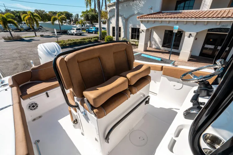 Slide: The Image of Interior view of 2025 Sea Hunt Ultra 255 SE boat with brown seating and steering wheel. - 27