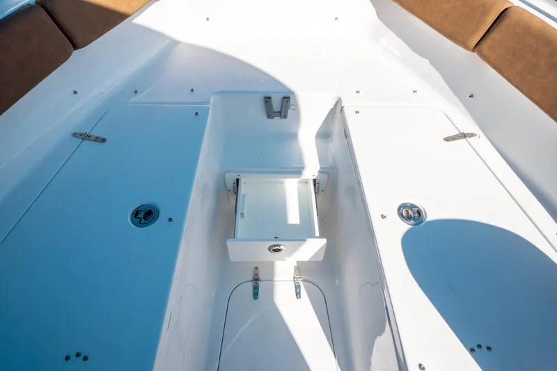 Slide: The Image of 2025 Sea Hunt Ultra 255 SE boat interior with storage compartments and seating. - 41