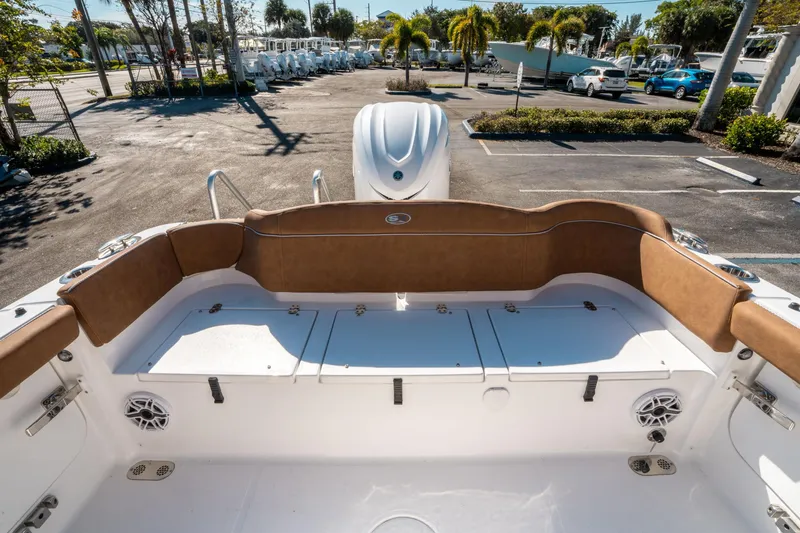 Slide: The Image of Interior view of 2025 Sea Hunt Ultra 255 SE boat with brown seating and storage compartments. - 13