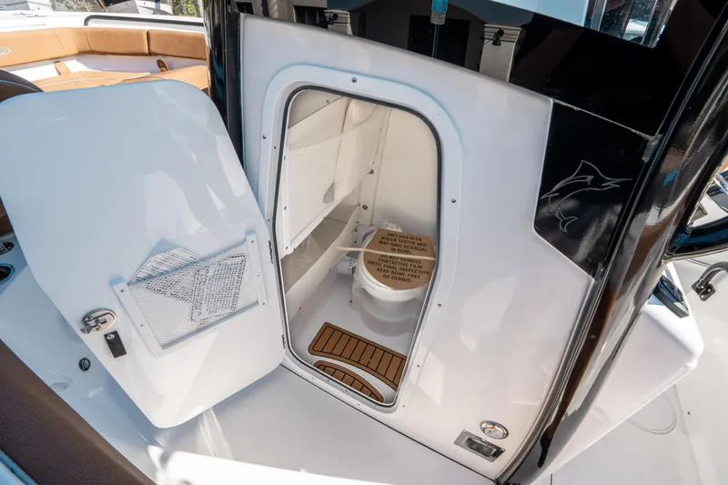Slide: The Image of Interior view of 2025 Sea Hunt Ultra 255 SE boat's compact restroom. - 30